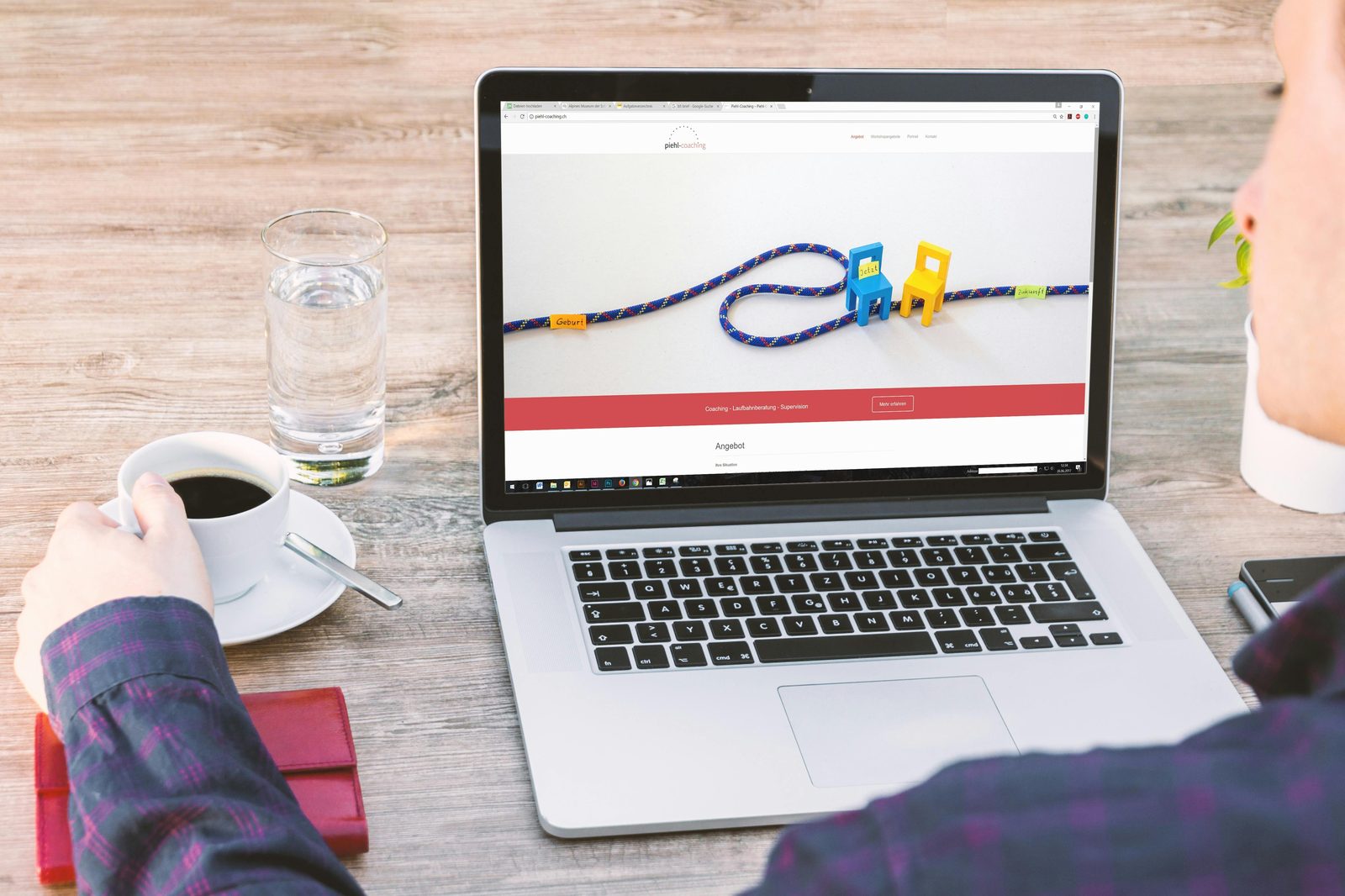Person reviewing a custom-designed website on a laptop with a cup of coffee