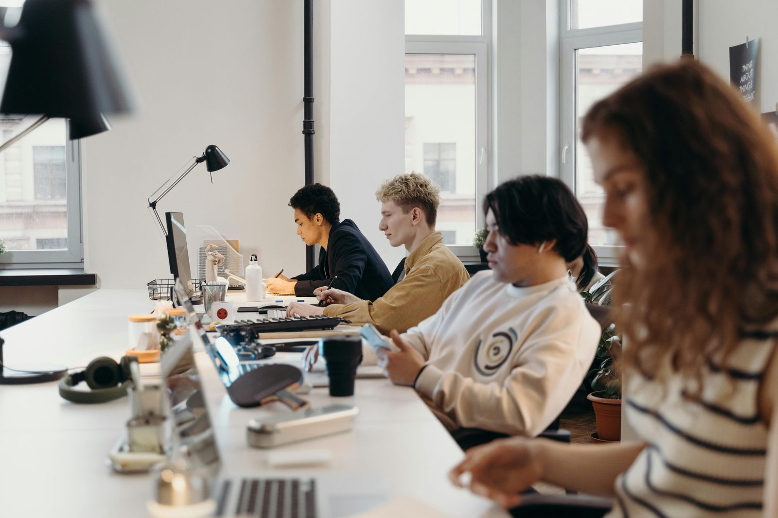 A team working together at a long desk in a bright modern office