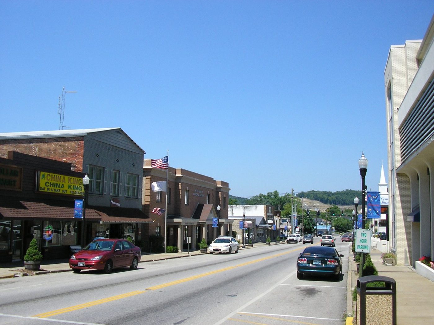 Main Street in historic downtown West Liberty, Kentucky with local shops and Appalachian hills in the distance